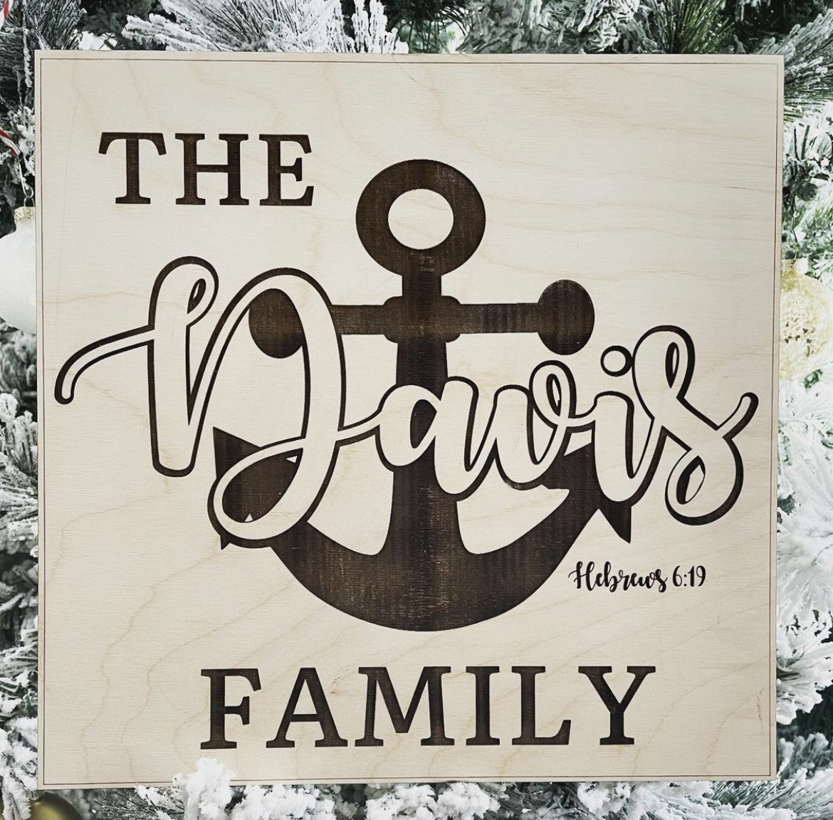 Engraved wood sign reading 'The Davis Family' with an anchor and Hebrews 6:19.