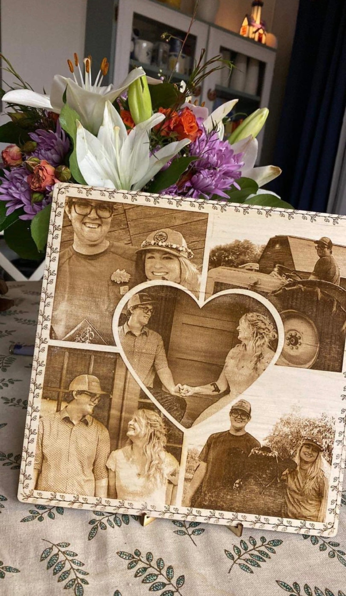Laser-engraved wooden photo collage with a heart-shaped centerpiece of a couple.